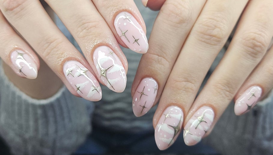Elegant nail art with stars and pink polish at Lucky Frog Nails, Newton Abbot, England, GB.