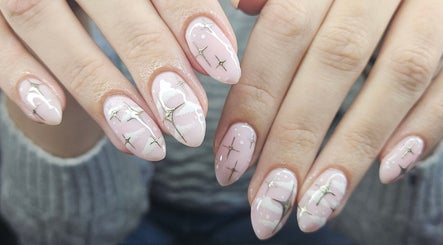 Elegant nail art with stars and pink polish at Lucky Frog Nails, Newton Abbot, England, GB.