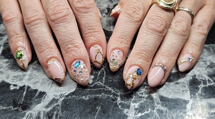 Elegant embellished nails at Lucky Frog Nails in Newton Abbot, England, GB, showcasing intricate gem designs.