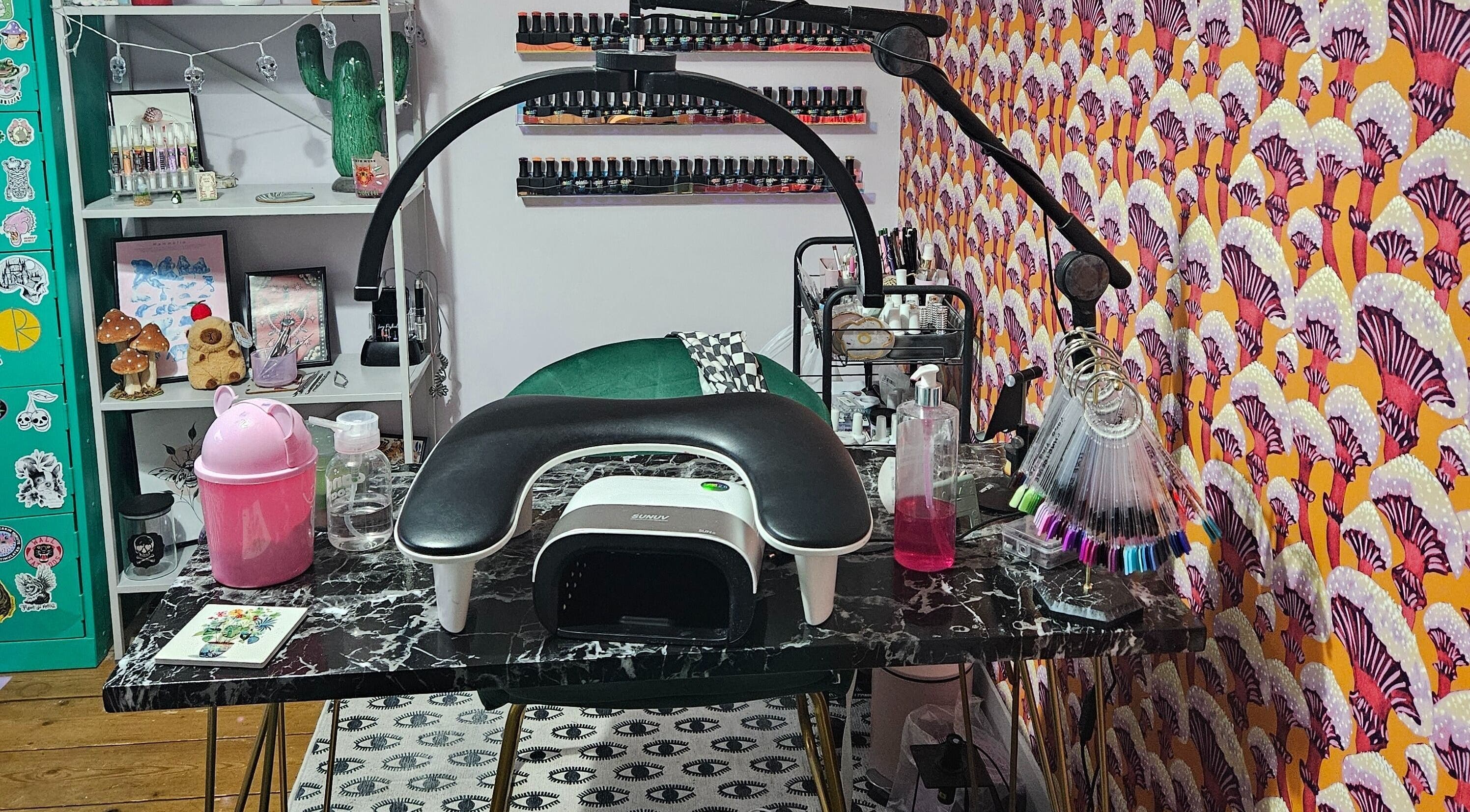 Lucky Frog Nails in Newton Abbot, England features a stylish nail art station with vibrant decor.