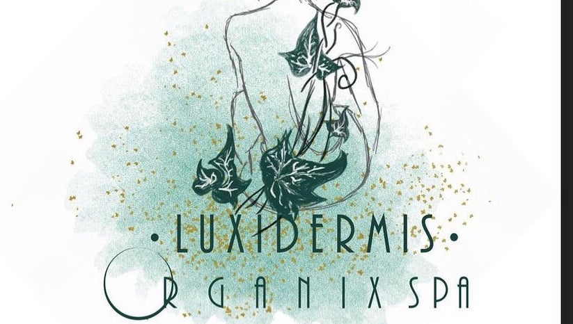 Artistic logo for Luxidermis Organix in Portmore, St. Catherine Parish, JM, featuring lush green ivy and gold flecks.