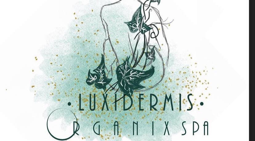 Artistic logo for Luxidermis Organix in Portmore, St. Catherine Parish, JM, featuring lush green ivy and gold flecks.