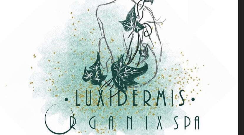 Artistic logo for Luxidermis Organix in Portmore, St. Catherine Parish, JM, featuring lush green ivy and gold flecks.