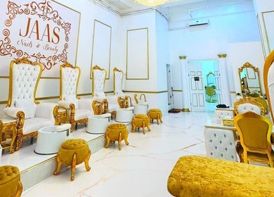 Luxurious interior of Jaas Nails and Beauty in Cebu City, Central Visayas, PH with golden chairs and footrests.