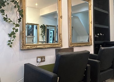 Chic salon chairs and ornate mirrors at Gem Hair Design in Greenmount, England, GB.