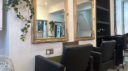 Chic salon chairs and ornate mirrors at Gem Hair Design in Greenmount, England, GB.