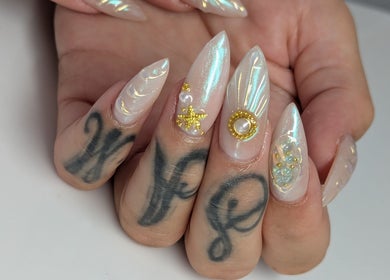 Intricate pearl and gold nail art at Kel's Nailz, Bristol, England, GB showcasing luxurious manicure.