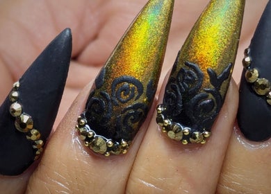 Stunning multicolor and black stiletto nails at Kel's Nailz in Bristol, England, GB with gemstone accents.