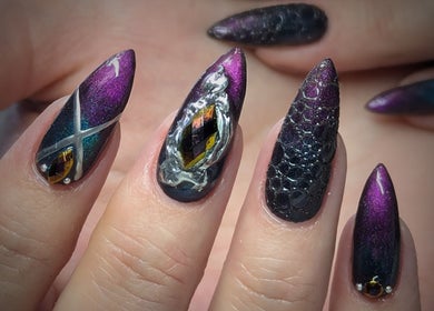 Elegant stiletto nails with purple and black designs at Kel's Nailz, Bristol, England, GB.
