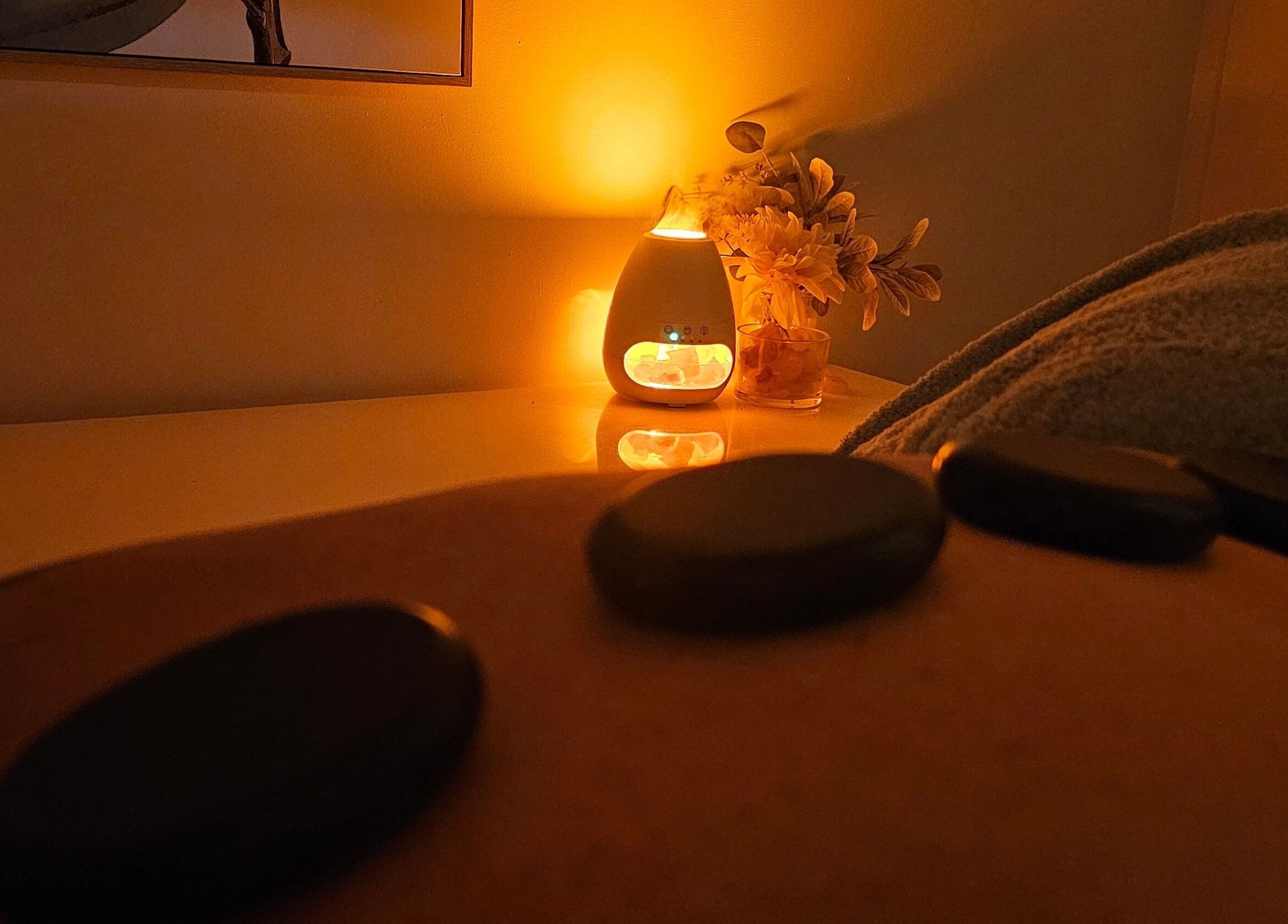 Relaxing hot stone massage at Sophrosyne Hair Serenity Studios, Toowoomba City, Queensland, AU by warm candlelight.