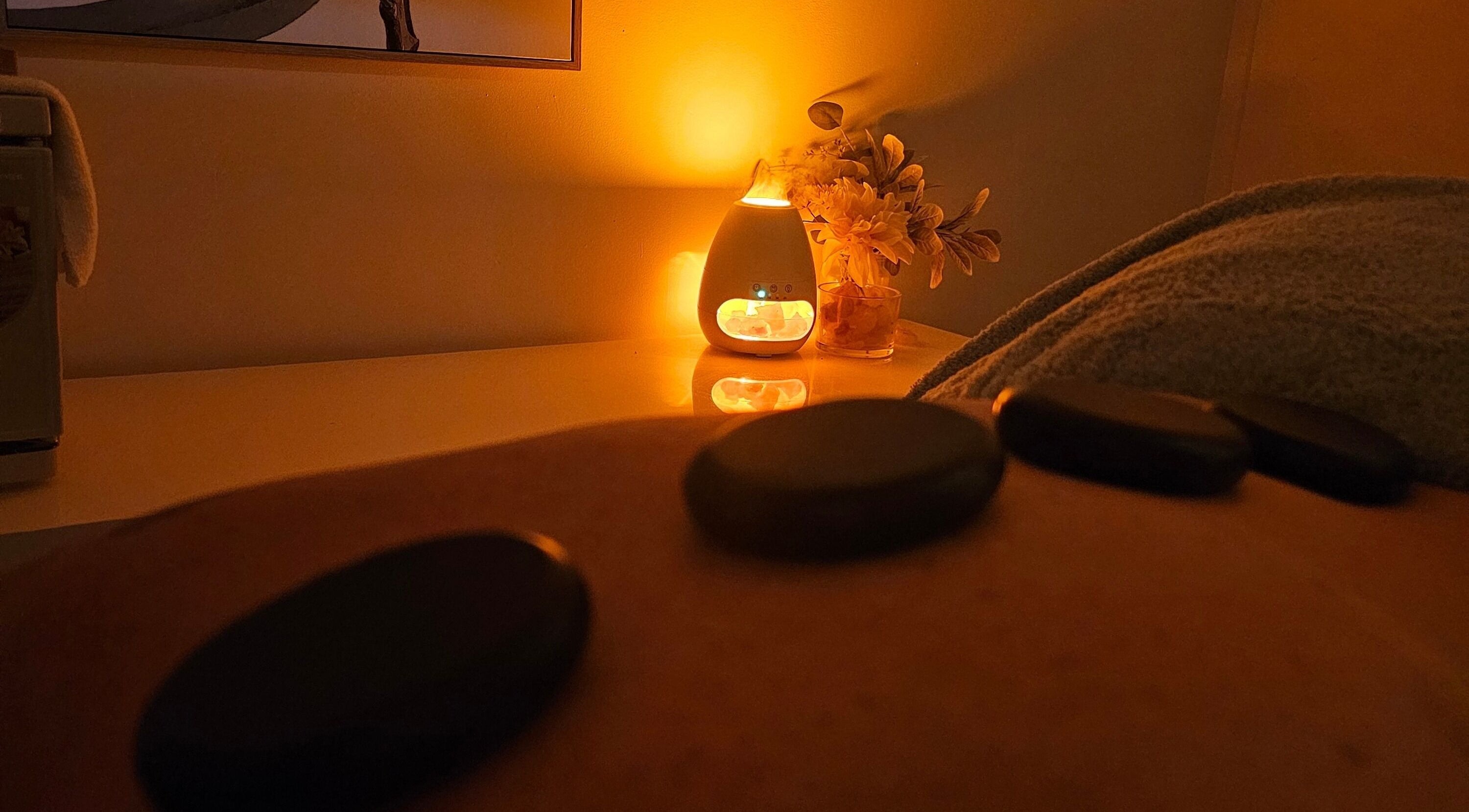 Relaxing hot stone massage at Sophrosyne Hair Serenity Studios, Toowoomba City, Queensland, AU by warm candlelight.