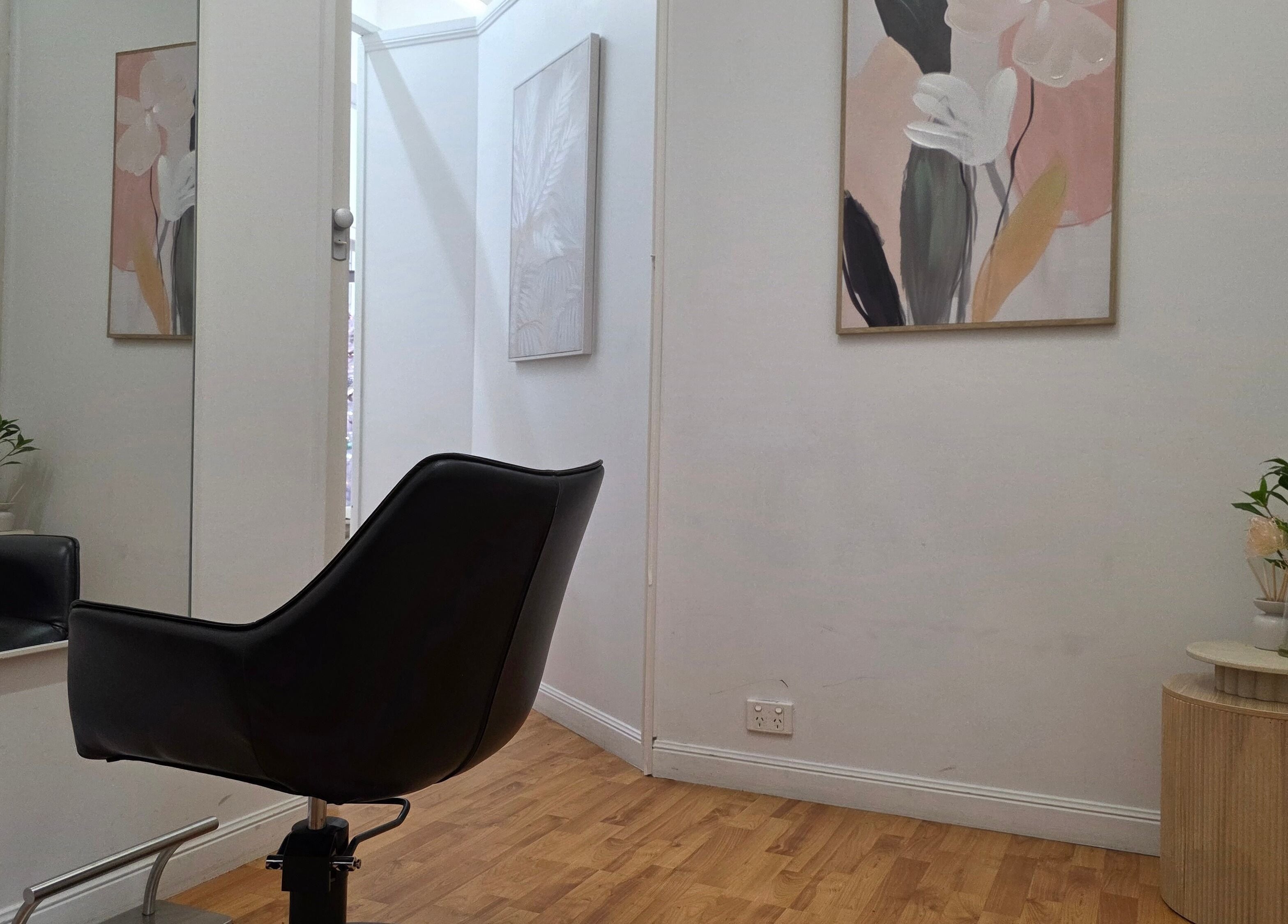 Cozy salon corner in Sophrosyne Hair Serenity Studios, Toowoomba City, Queensland, AU with chic decor and art.