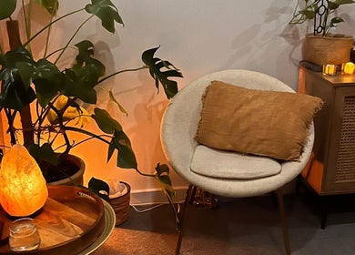 Cozy, serene corner at Lomi Massage Geelong, Newtown, Victoria, AU, featuring a warm-lit salt lamp and plush seating.