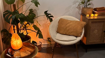 Cozy, serene corner at Lomi Massage Geelong, Newtown, Victoria, AU, featuring a warm-lit salt lamp and plush seating.