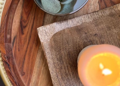 Peaceful setup at Lomi Massage Geelong, Newtown, Victoria, AU with glowing candle and wooden elements.