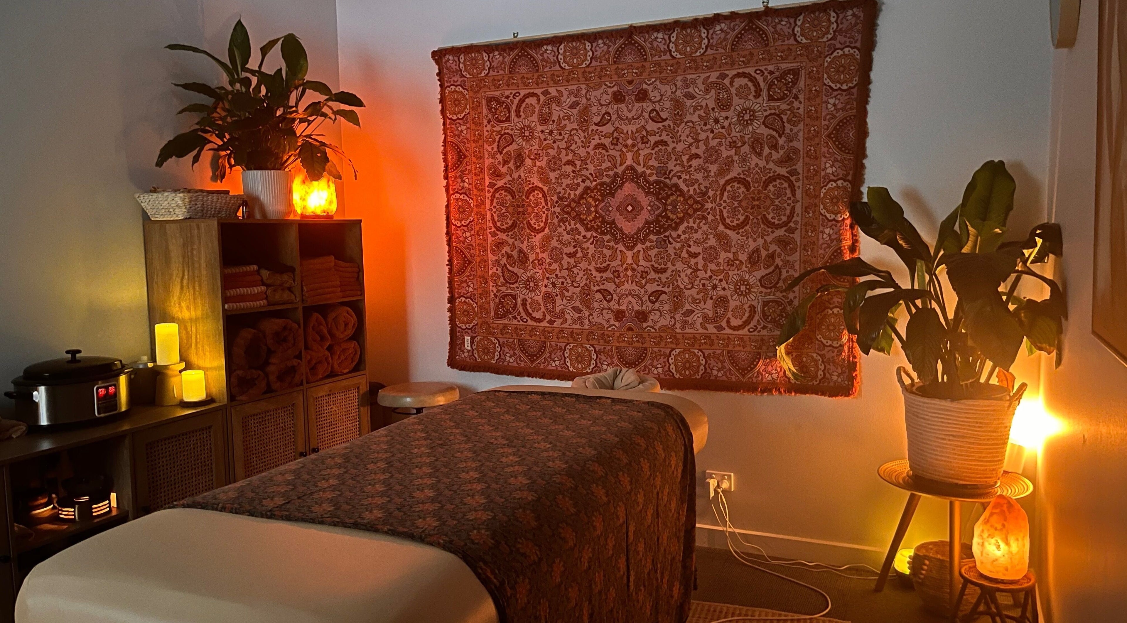 Relaxing massage room at Lomi Massage Geelong in Newtown, Victoria, AU with warm lighting and cozy decor.