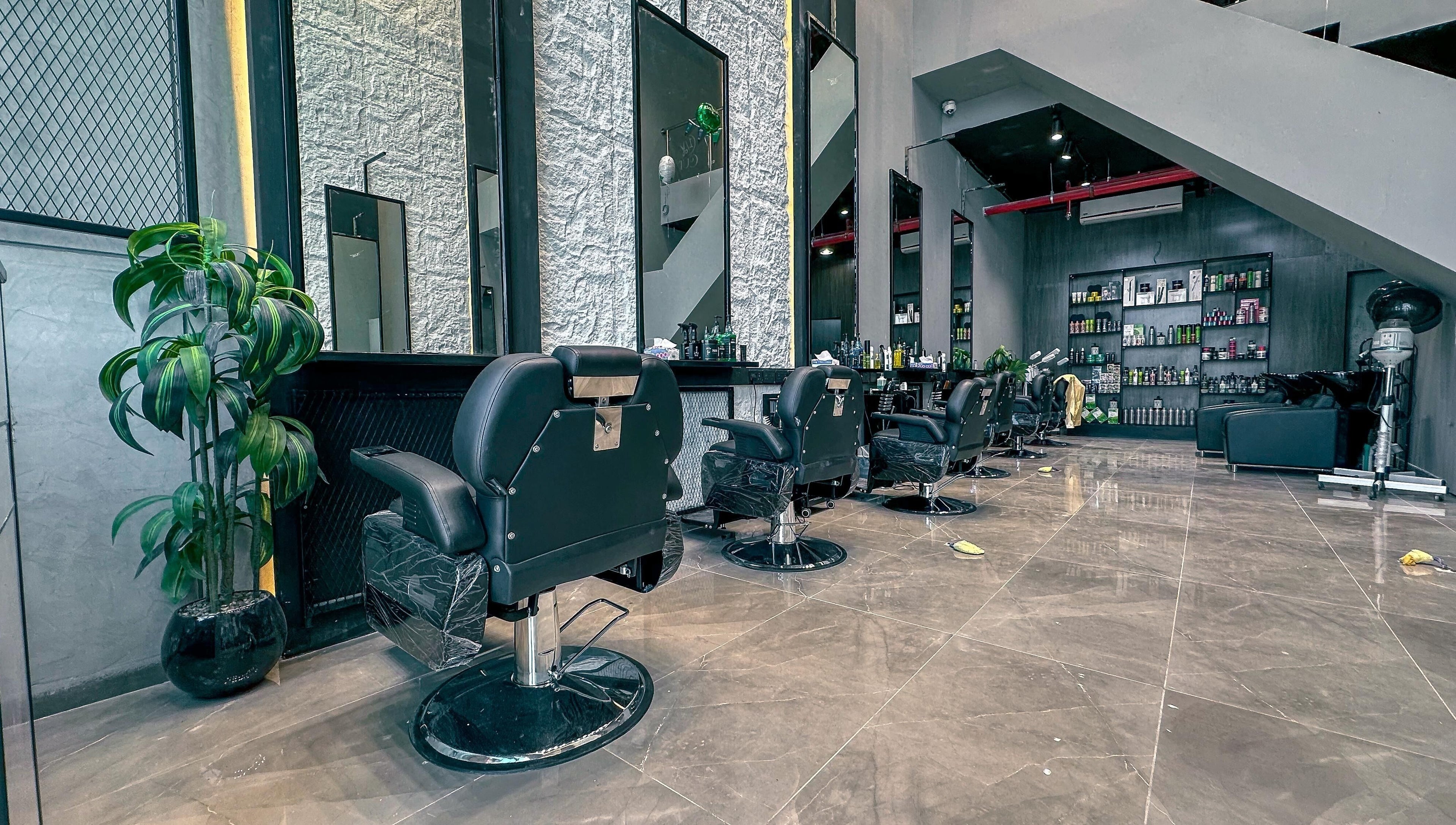 Modern interior of 1/2 Cuts Salon صالون هاف كت | Al Dammam, showcasing sleek styling chairs and decor in Dammam, Eastern Province, SA.