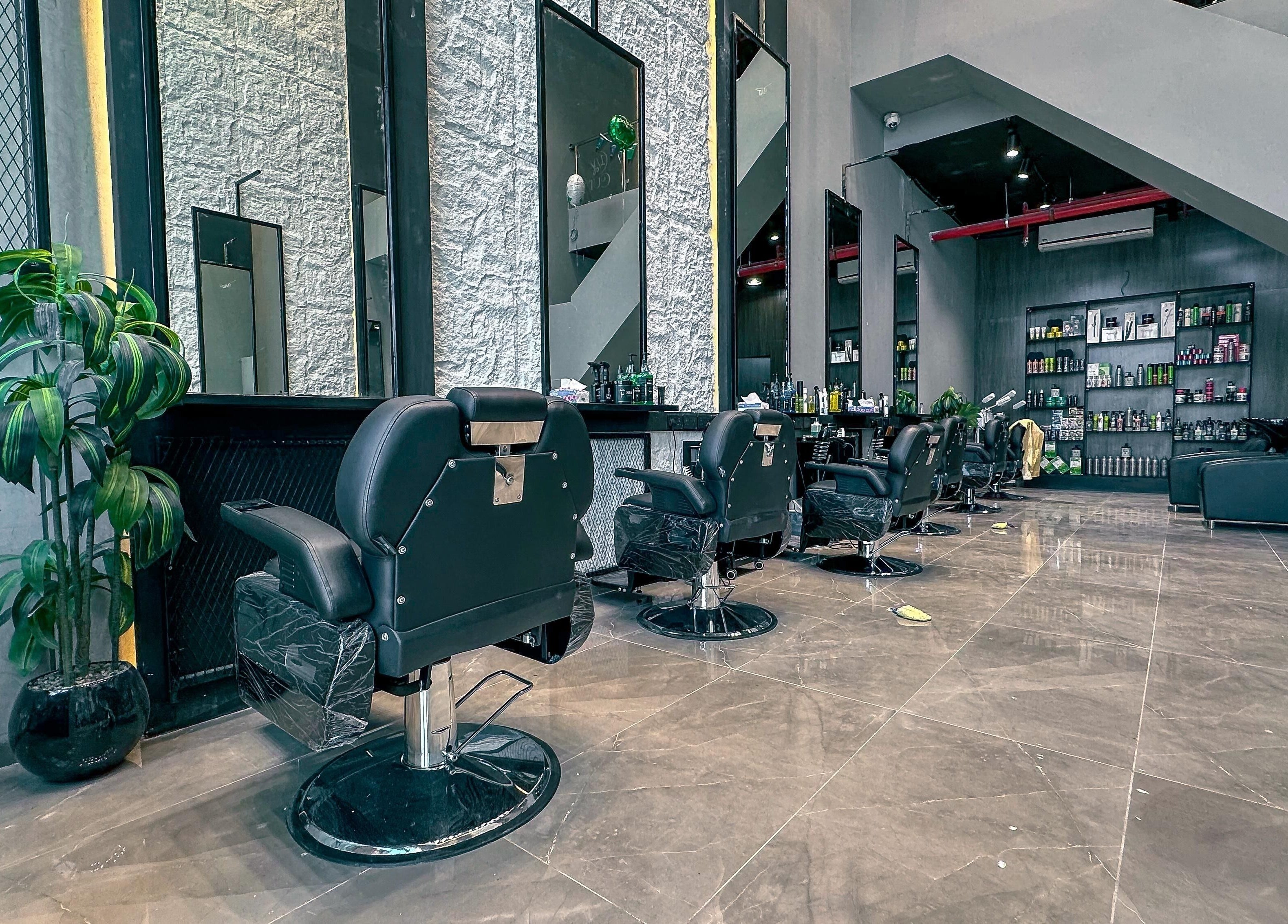 Modern interior of 1/2 Cuts Salon صالون هاف كت | Al Dammam, showcasing sleek styling chairs and decor in Dammam, Eastern Province, SA.