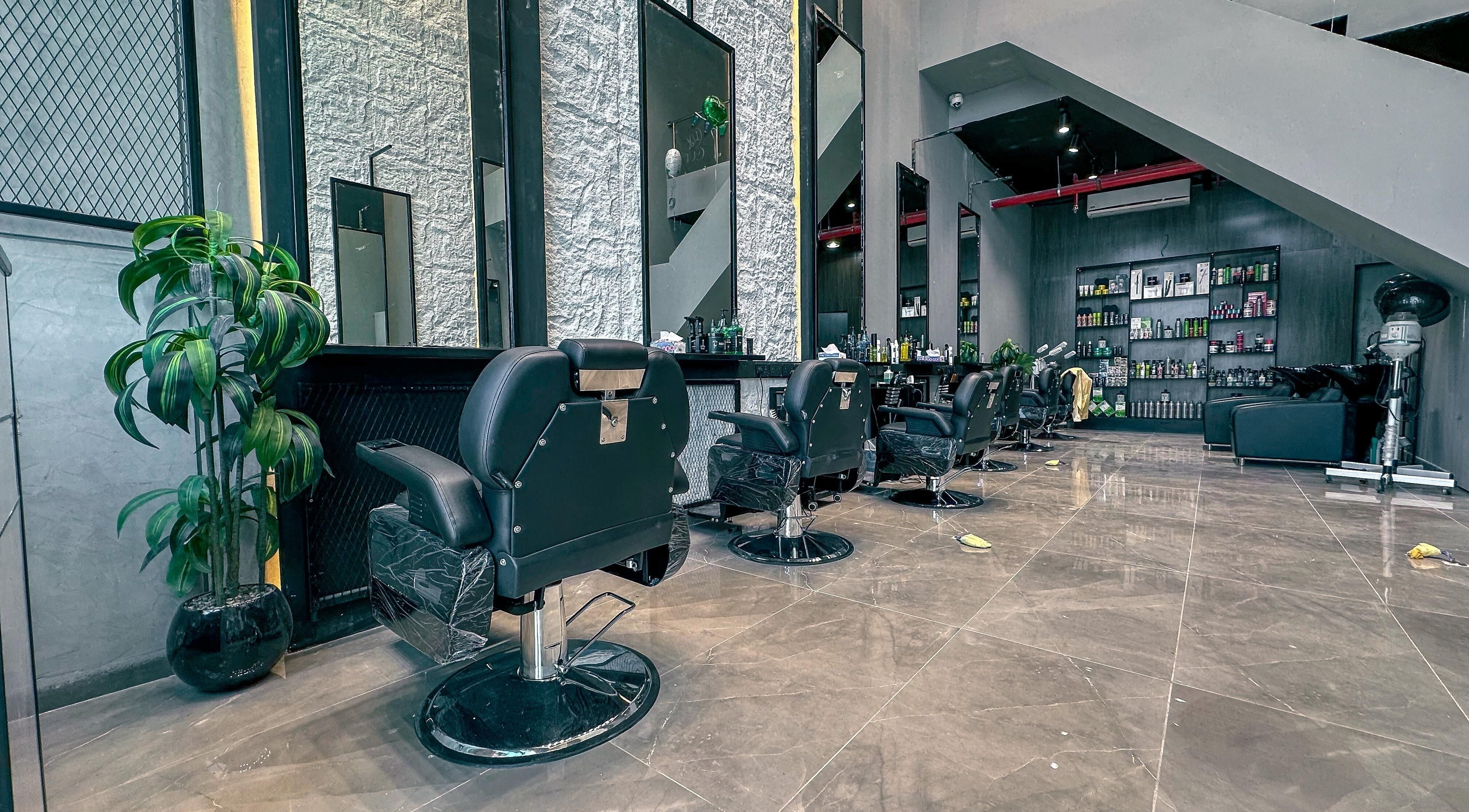 Modern interior of 1/2 Cuts Salon صالون هاف كت | Al Dammam, showcasing sleek styling chairs and decor in Dammam, Eastern Province, SA.