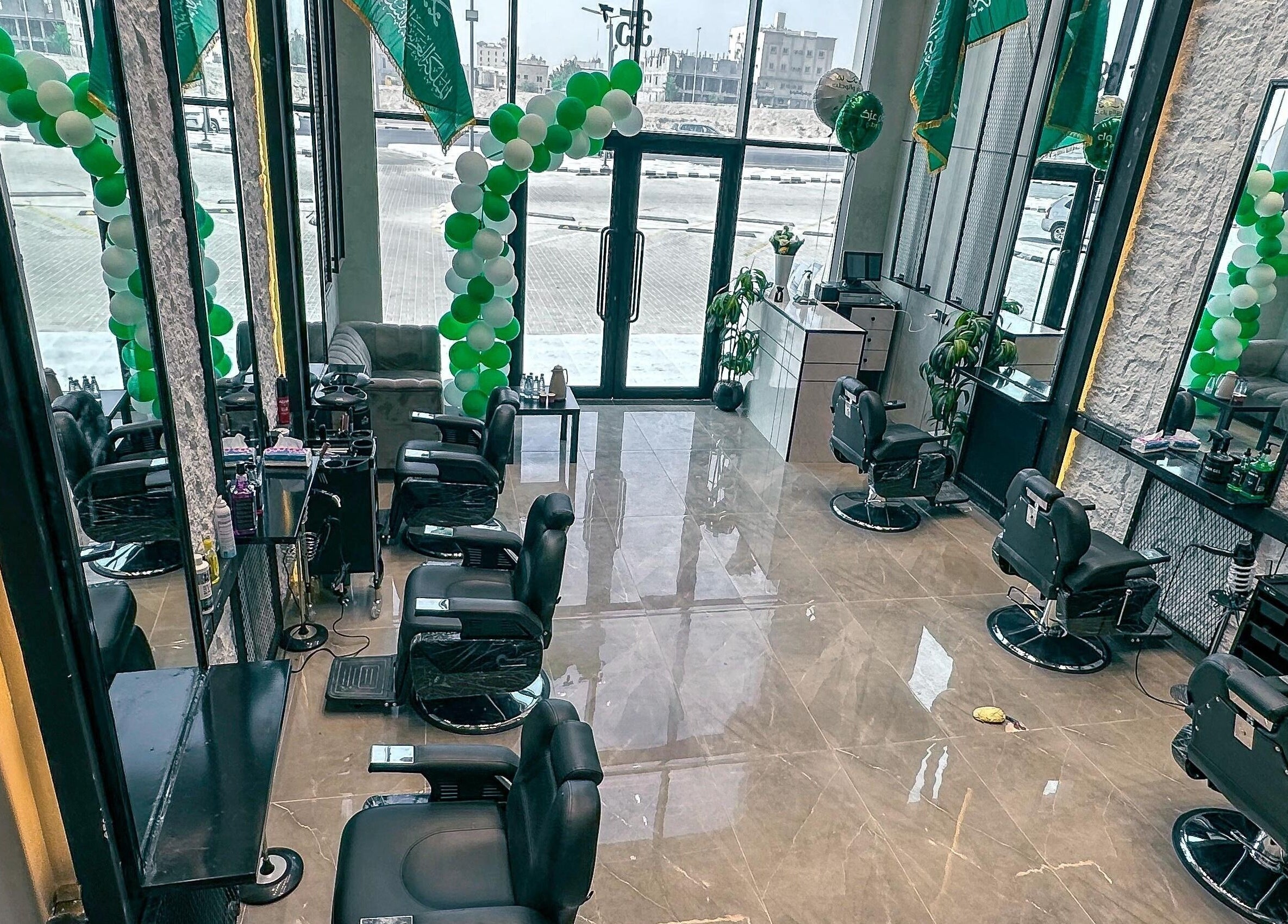 Spacious interior of 1/2 Cuts Salon صالون هاف كت | Al Dammam in Dammam, featuring modern styling chairs.
