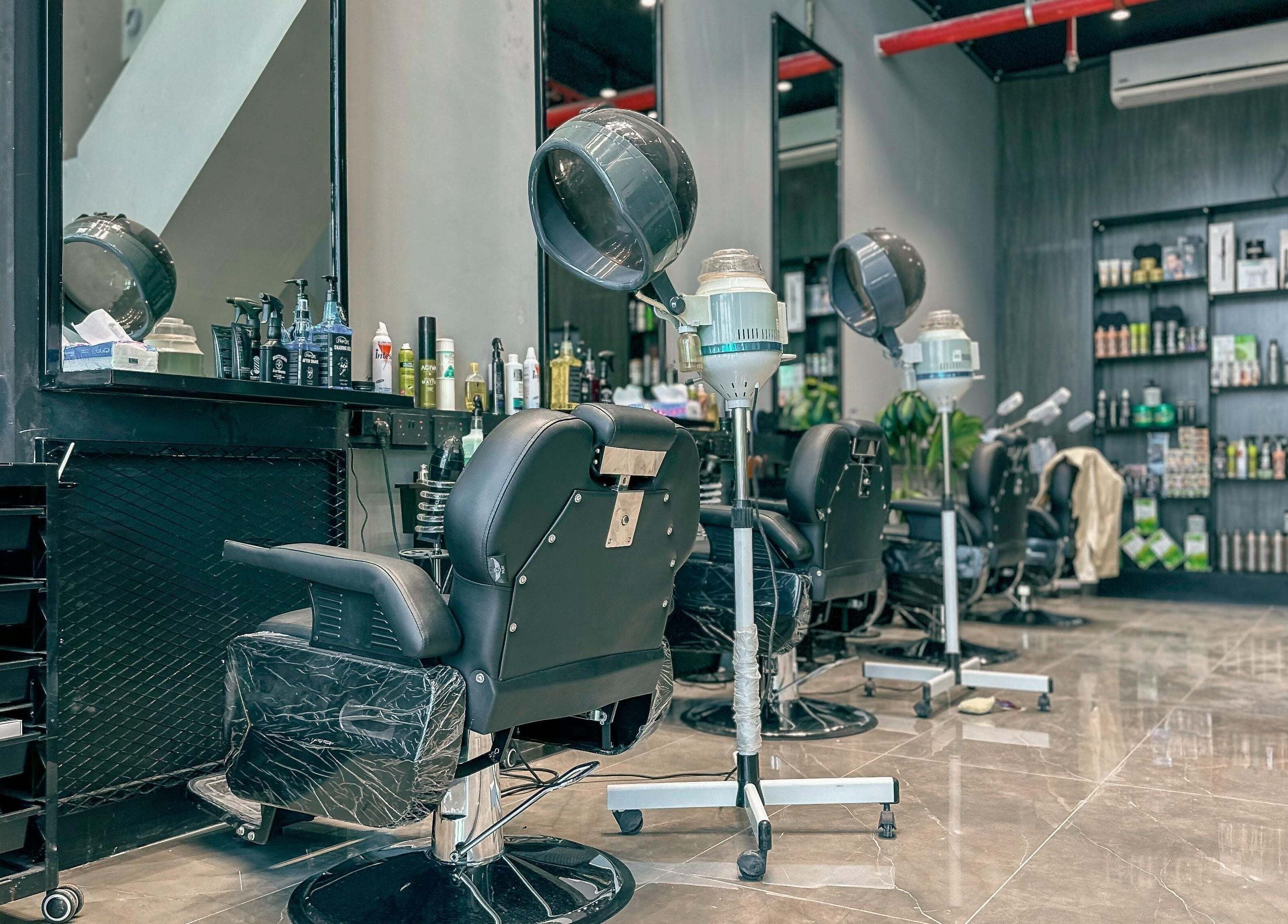 Modern salon setup at 1/2 Cuts Salon صالون هاف كت | Al Dammam, Dammam, Eastern Province, SA, showcasing stylish chairs and shelves.