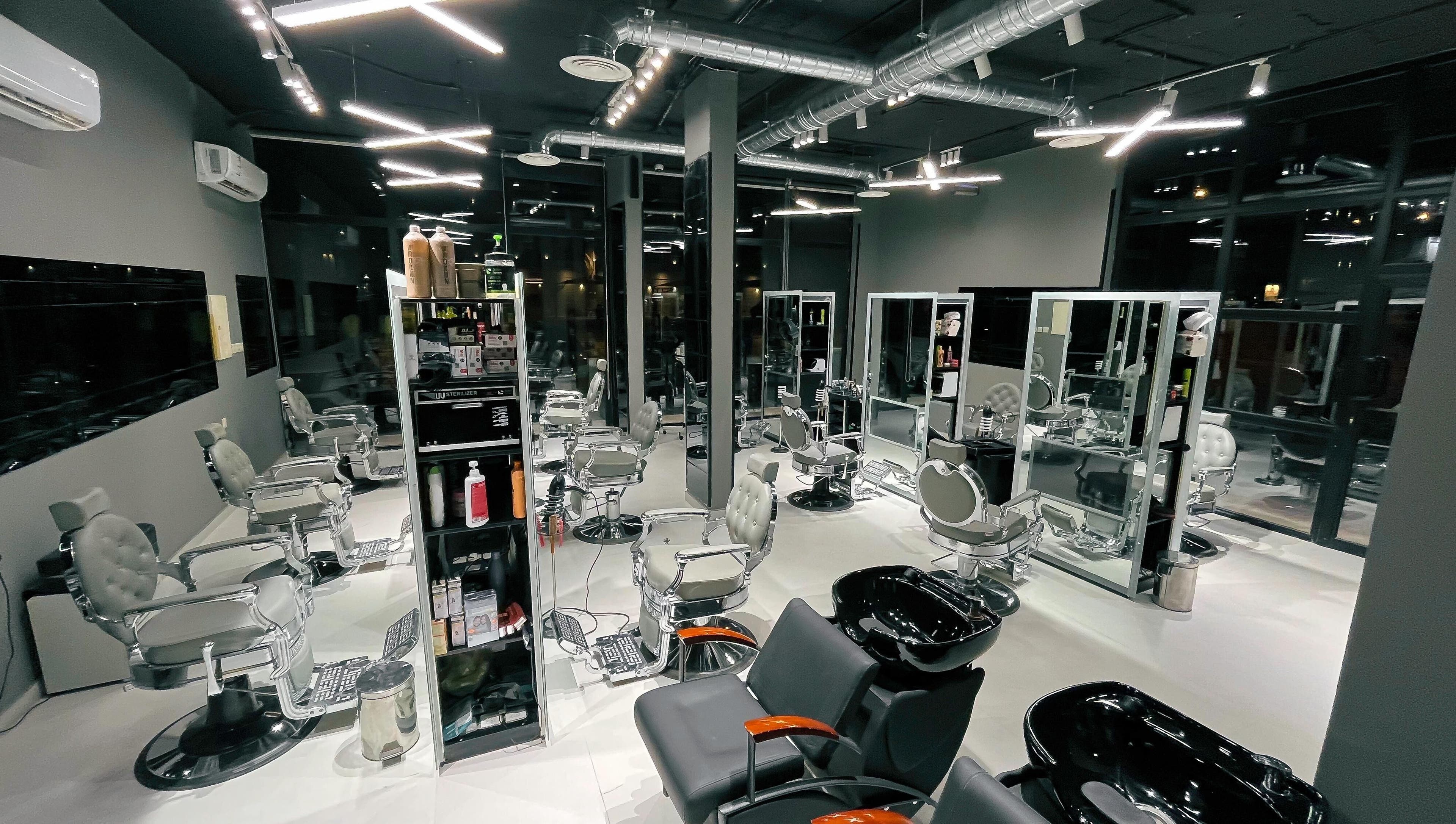 Modern interior of 1/2 Cuts Salon صالون هاف كت | Al Narjis in Riyadh, Riyadh Province, SA with sleek styling chairs.