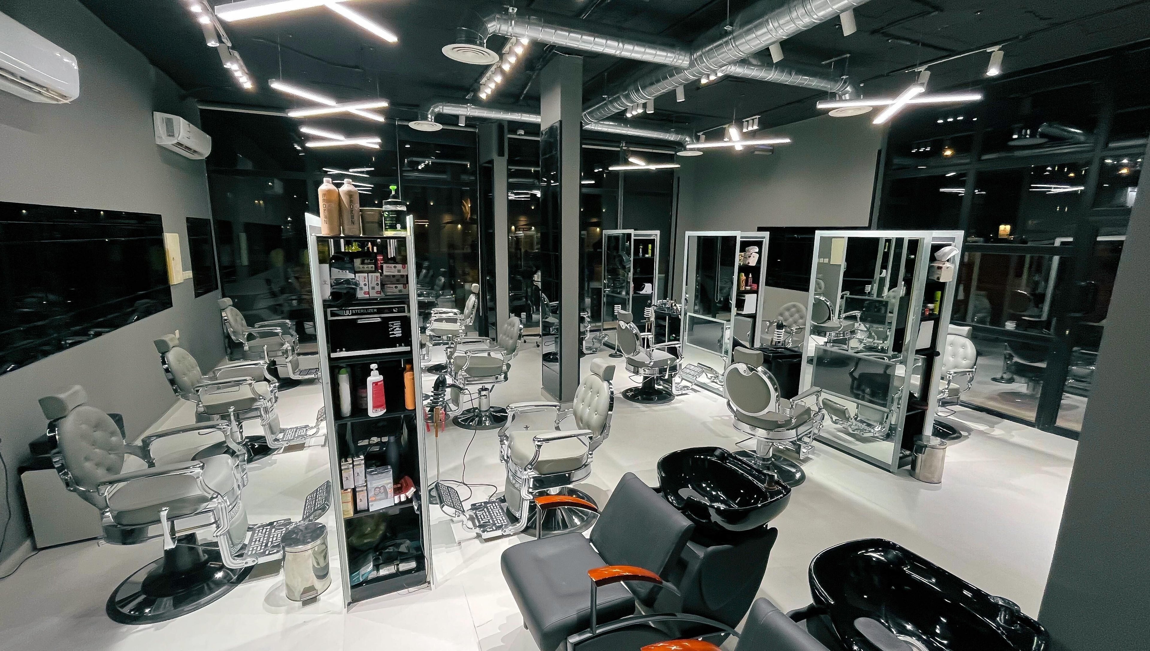 Modern interior of 1/2 Cuts Salon صالون هاف كت | Al Narjis in Riyadh, Riyadh Province, SA with sleek styling chairs.