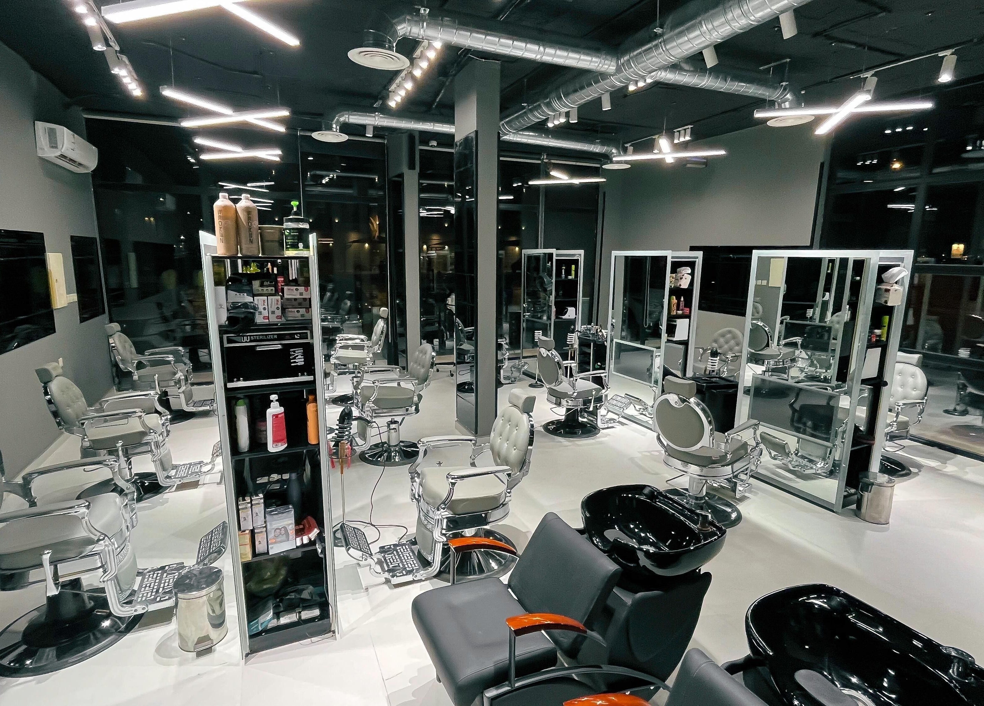 Modern interior of 1/2 Cuts Salon صالون هاف كت | Al Narjis in Riyadh, Riyadh Province, SA with sleek styling chairs.