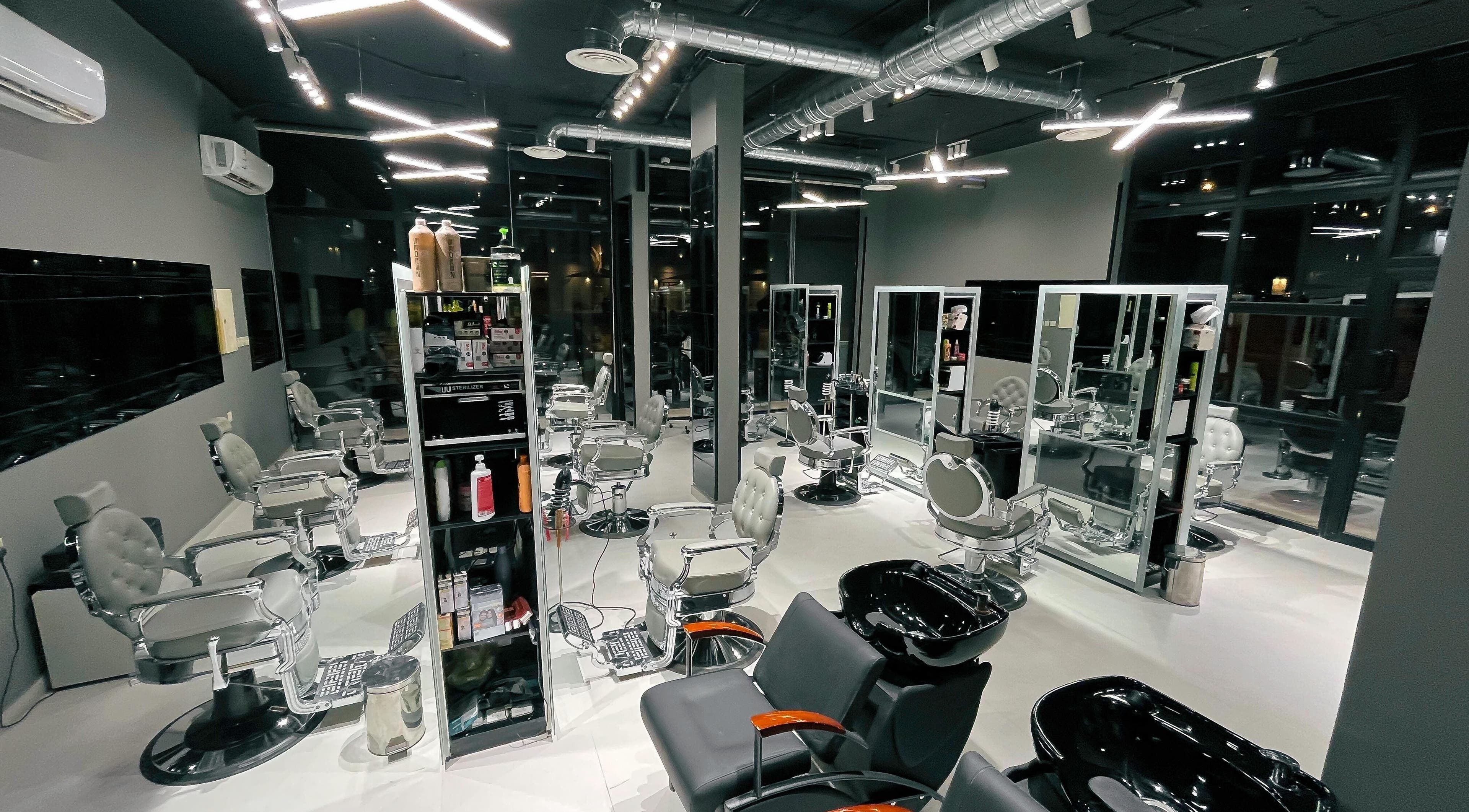 Modern interior of 1/2 Cuts Salon صالون هاف كت | Al Narjis in Riyadh, Riyadh Province, SA with sleek styling chairs.