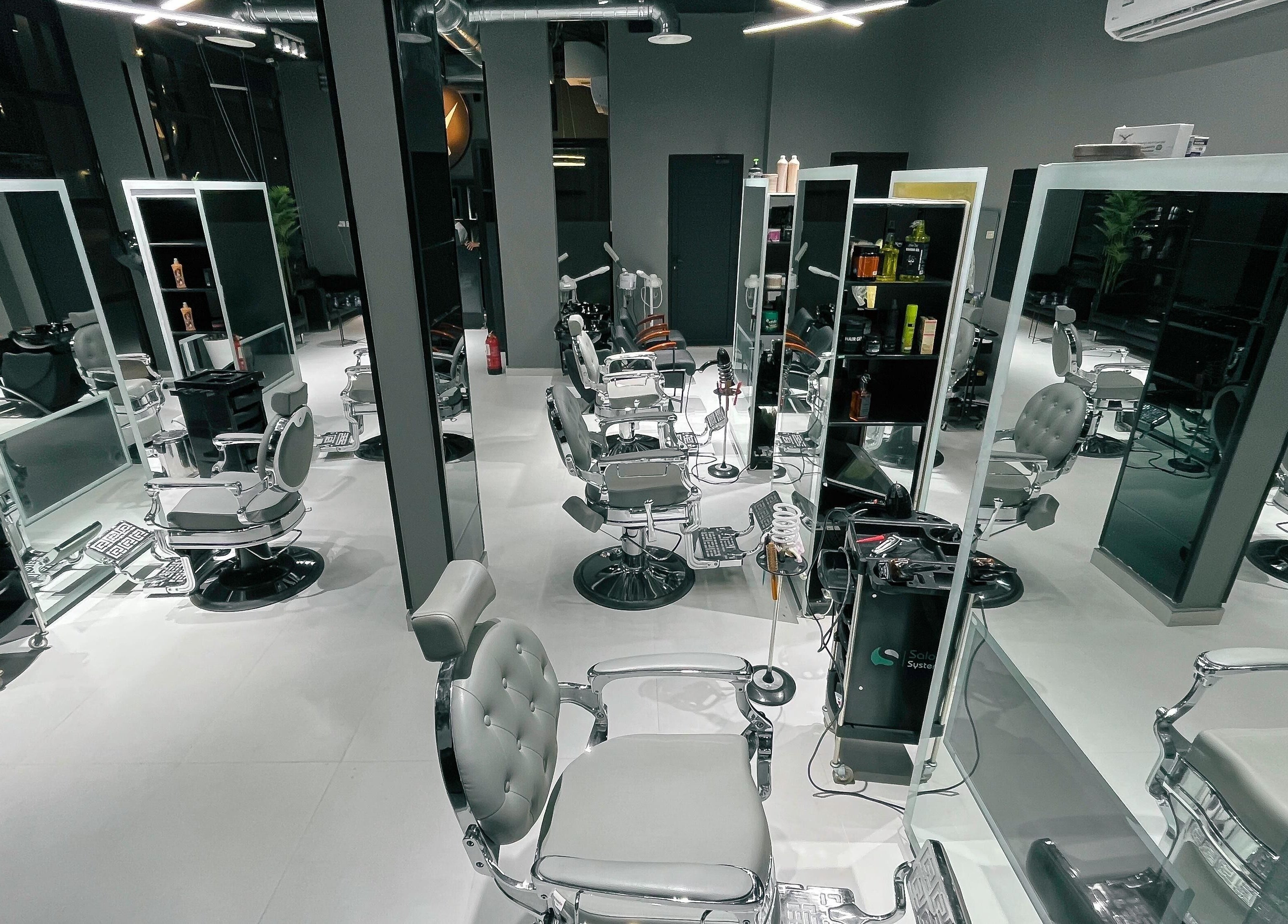 Elegant interior of 1/2 Cuts Salon صالون هاف كت | Al Narjis, Riyadh, Riyadh Province, SA with modern styling chairs.
