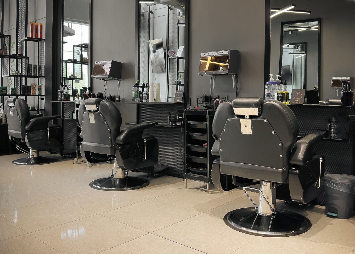 Luxurious interior of 1/2 Cuts Salon صالون هاف كت | Al Shifa in Riyadh, sophisticated and modern chairs.