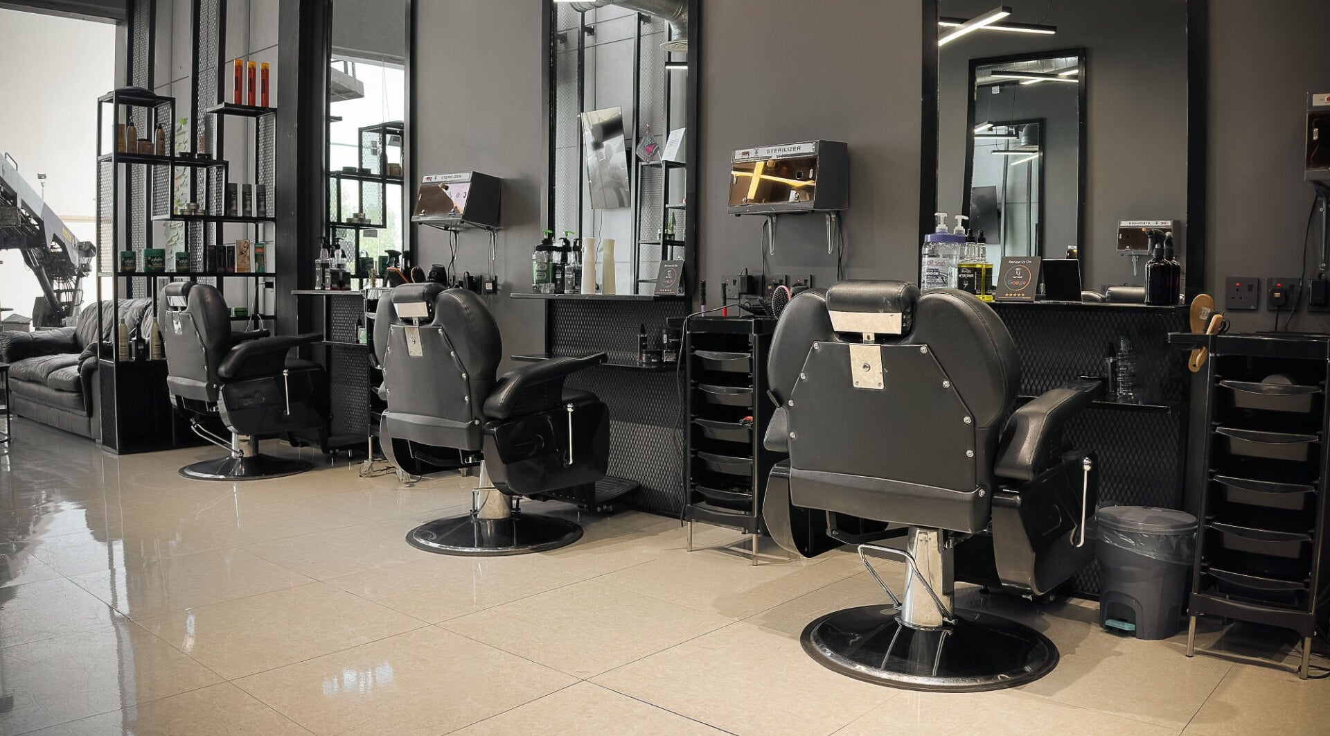 Luxurious interior of 1/2 Cuts Salon صالون هاف كت | Al Shifa in Riyadh, sophisticated and modern chairs.