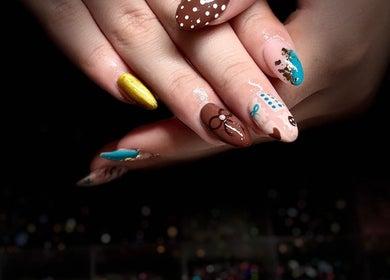 Colorful nail art design at Nails by Lauren in Live Oak, Florida, US showcasing intricate patterns.