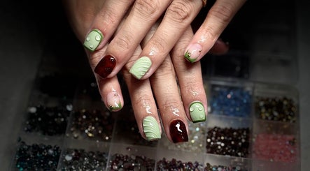 Elegant nail art with green accents at Nails by Lauren, Live Oak, Florida, US.