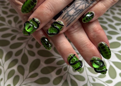 Stylish green nail art with black details at Nails by Lauren, Live Oak, Florida, US.