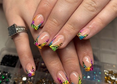 Colorful zebra-striped nails at Nails by Lauren in Live Oak, Florida, US. Stylish and vibrant nail art.