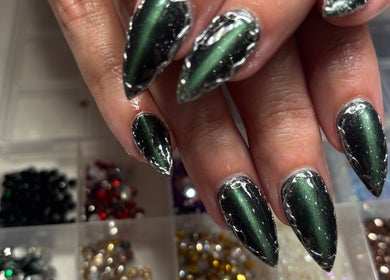 Stunning emerald nails with sparkles at Nails by Lauren, Live Oak, Florida, US.