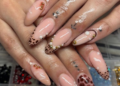 Intricate nail art design at Nails by Lauren in Live Oak, Florida, US with beads and animal prints.