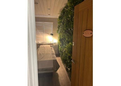Relaxing massage room at Helen Wright Sports Massage Therapist, Derby, England, GB, with cozy lighting and lush decor.