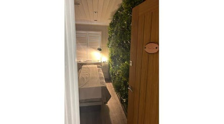 Relaxing massage room at Helen Wright Sports Massage Therapist, Derby, England, GB, with cozy lighting and lush decor.