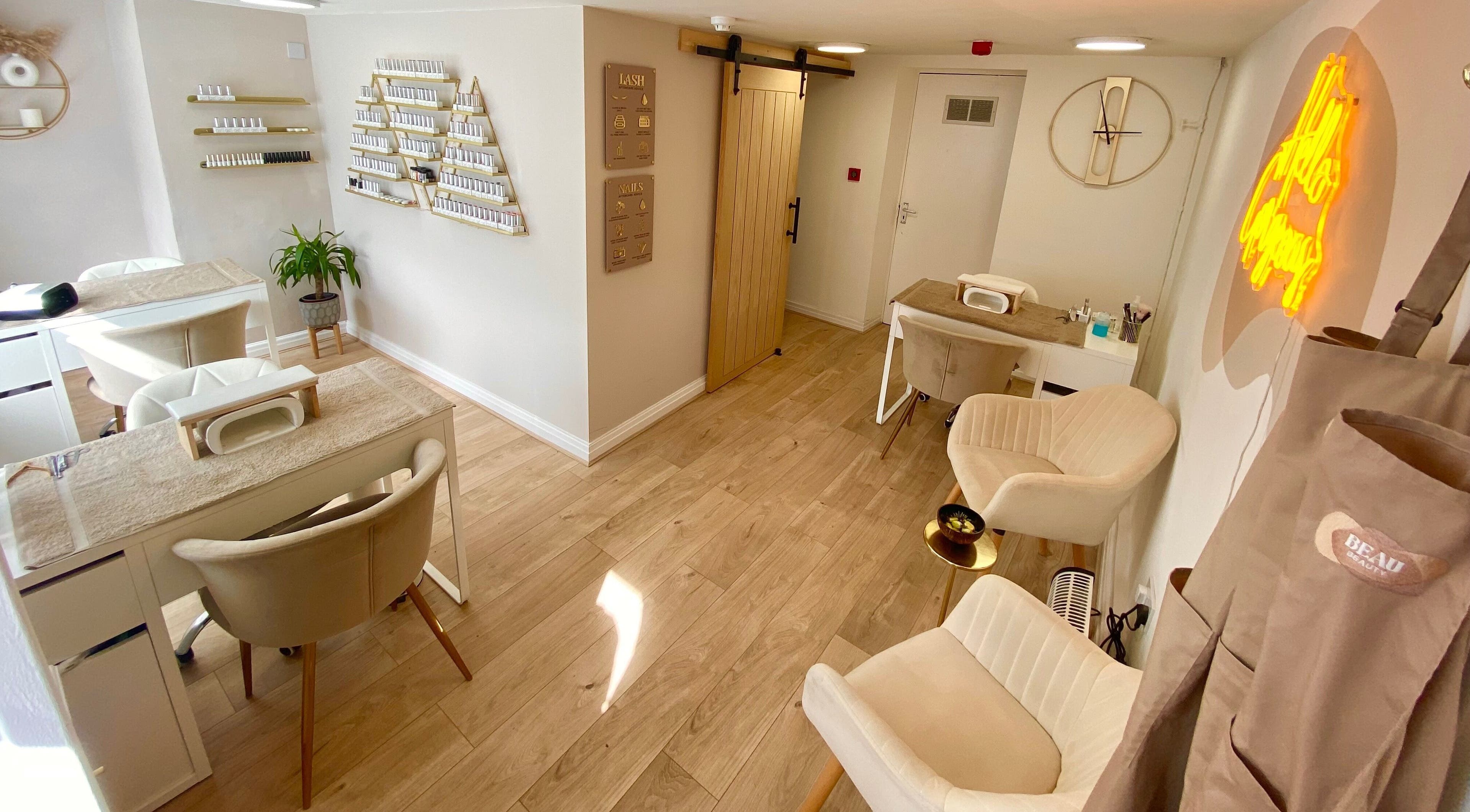 Elegant nail salon interior at Beau Beauty, Douglas, Douglas, IM, featuring modern decor and plush seating.