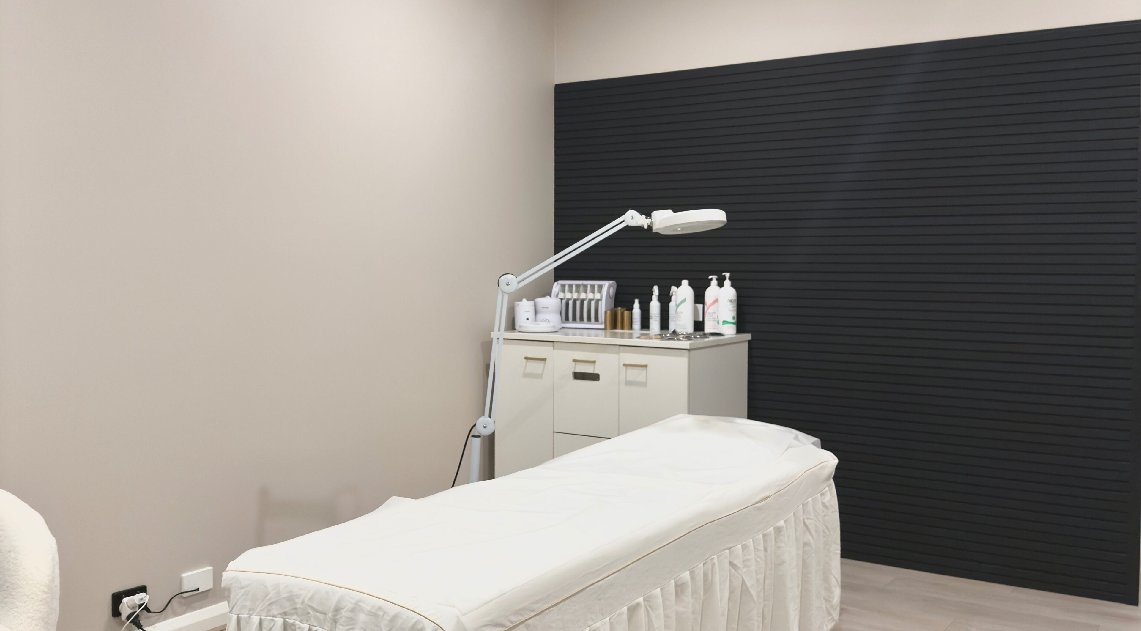 Elegant treatment room at Lawish Beauty, Melbourne, Victoria, AU, featuring a spa bed and beauty products.