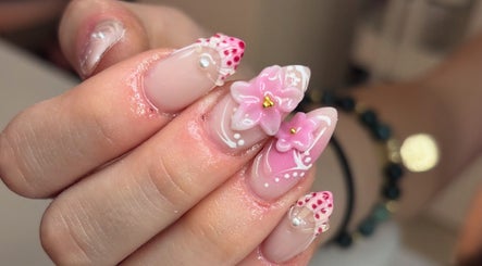 Beautiful floral nail art at Manis By Maisie in Lincoln, England, GB, showcasing intricate pink flower designs.