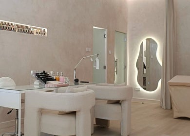 Modern nail care area at LBK Paris Beauty Salon, Dubai, AE, featuring plush chairs and sleek design.