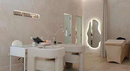 Modern nail care area at LBK Paris Beauty Salon, Dubai, AE, featuring plush chairs and sleek design.