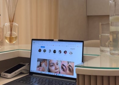 LBK Paris Beauty Salon's sleek counter featuring a laptop in Dubai, AE.