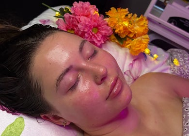 A woman enjoys a facial treatment at Hannah’s Lilac Room, Mccordsville, Indiana, US, surrounded by flowers.
