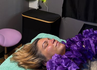 Relaxing facial treatment at Hannah’s Lilac Room, Mccordsville, Indiana, US with purple floral decor.