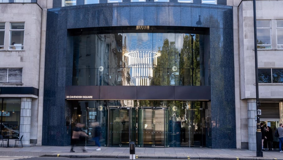 Modern glass facade of Dejavu Lashes Mayfair in London, England, GB, showcasing contemporary design.