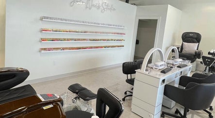 Chic interior of Joir Nails Studio Inc. in Bedford, Nova Scotia, CA showcasing sleek nail stations and polish display.